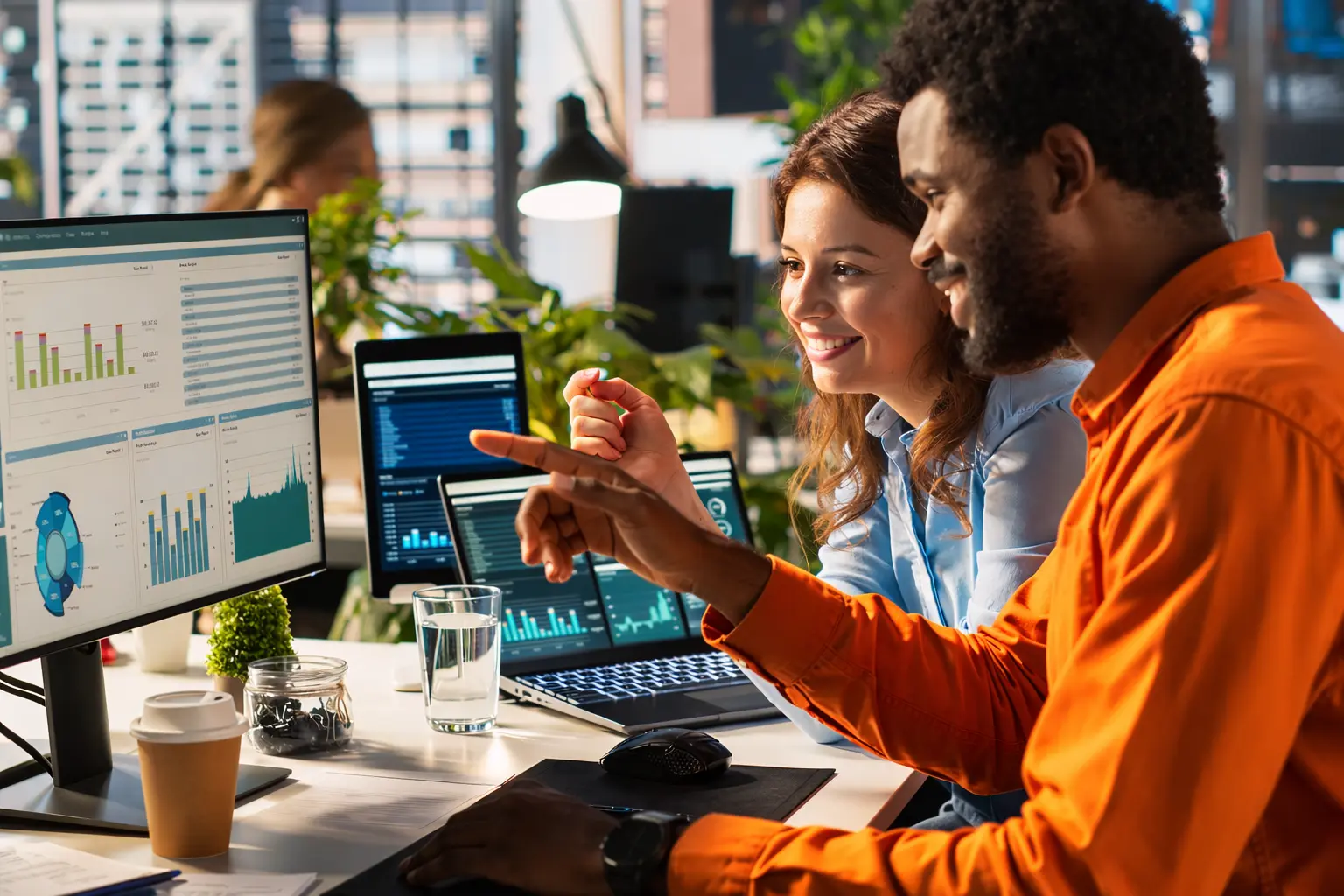 Team members working together at their monitors